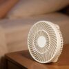 Foldable Handheld and Desktop Mini Fan, showing its stable folded desktop form and spiral front grille details.