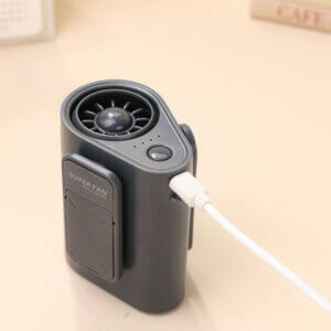 Multifunctional Waist and Neck Mounted Outdoor Portable Fan, showing its capsule-shaped body, turbine air outlet, and the deployed stable clip-stand structure at the bottom.