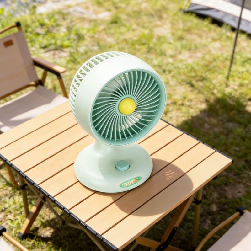 Automatic Oscillating Desktop Quiet Mini Fan, showing its white and blue two-tone appearance, spiral grille, and blue knob switch on the base.