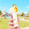 Cute Cartoon Figurine Handheld Mini Fan, showing its top 3D animal figurines, circular fan head, and printed handles in pink and yellow accents.