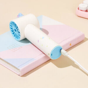 Cute Cartoon Figurine Handheld Mini Fan, showing its top 3D animal figurines, circular fan head, and printed handles in pink and yellow accents.