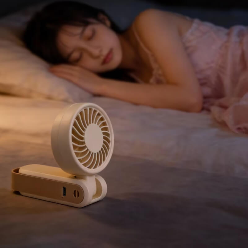 Foldable Neck and Bag Hanging High-Speed Handheld Fan, showing its beige body, folding joint, front grille, and multifunctional hanging loop structure at the bottom.