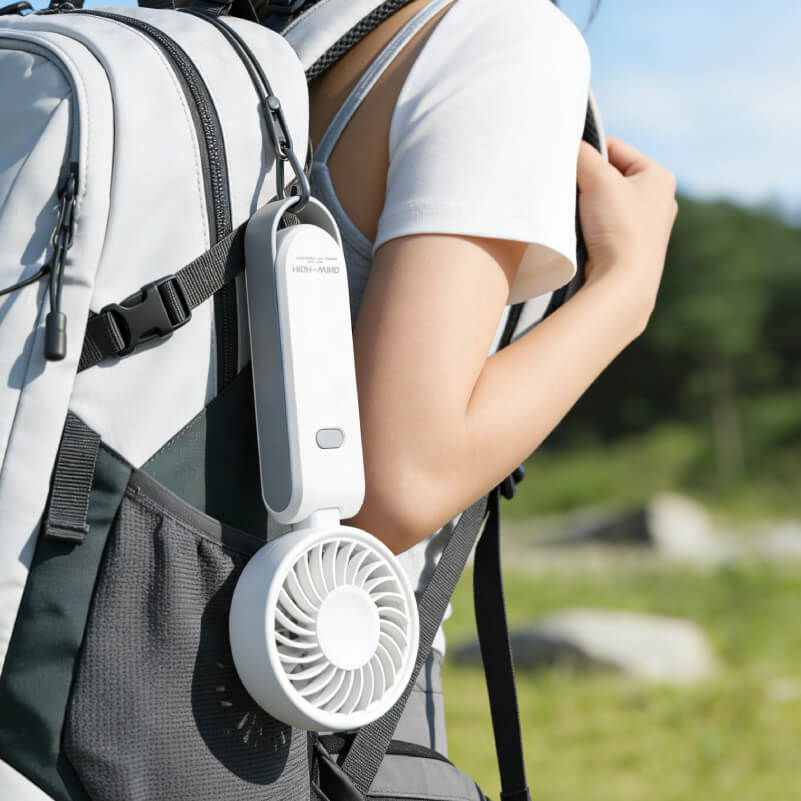 Foldable Neck and Bag Hanging High-Speed Handheld Fan, showing its beige body, folding joint, front grille, and multifunctional hanging loop structure at the bottom.