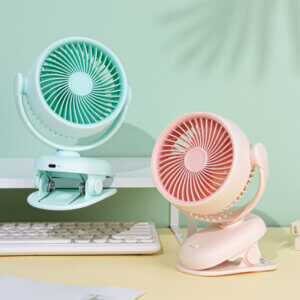 Automatic Oscillating Clip-on Desktop Mini Fan, showing its mint green appearance, spiral air guide grille, tilt-adjustable U-bracket, and clamp base with control button.