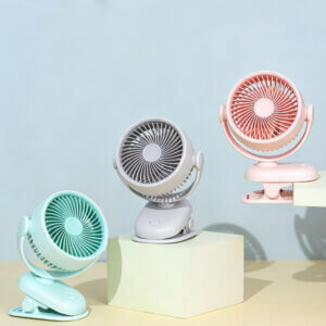 Automatic Oscillating Clip-on Desktop Mini Fan, showing its mint green appearance, spiral air guide grille, tilt-adjustable U-bracket, and clamp base with control button.